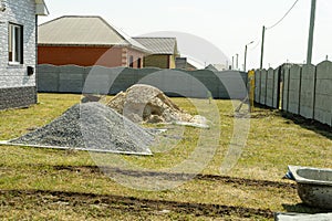 Piles of rubble and sand are stacked on the construction site