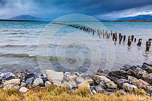 Piles of ruined pier protruding from the water