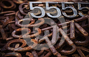 Piles of rusty metal numbers and letters