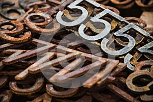 Piles of rusty metal numbers and letters