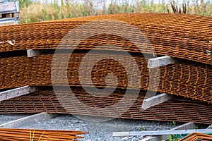 Piles of rusty rebar ready to be used at a construction site..