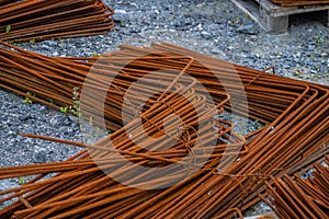 Piles of rusty rebar ready to be used at a construction site..