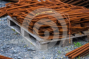 Piles of rusty rebar ready to be used at a construction site..