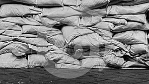 Piles of sandbags to prevent flooding on the cement floor.