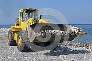 Piles of shingle dumped on the beach shore replenish and widen. photo