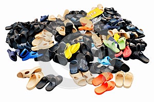 Piles of shoes sold in various color combinations rural land market, sandals, casual shoes, old. on white background