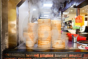 Piles of stacking bamboo steamers are steaming for dim sum
