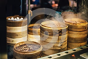 Piles of stacking bamboo steamers are steaming for dim sum. Street food of Jiantan in Taipei, Taiwan photo