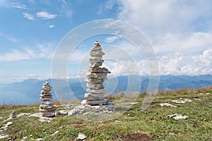 Piles of stones piled up by hikers on the summit of Monte Baldo on Lake Garda in Italy