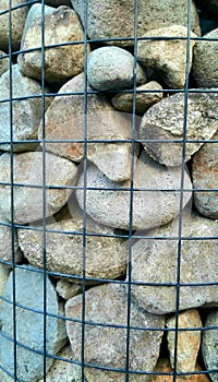 piles of stones strung together with iron netting