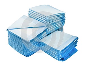 Piles of toilet pads for pets isolated on white. home leak proog training pads for animals