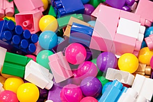 Piles of toys. A lot of colorful toys including balls and plastic construction toys or building blocks, top view. Toy for children