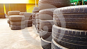 Piles of used car tires at a car maintenance garage