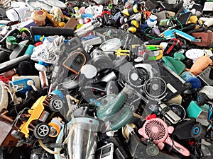 Piles of used electronic and household items are cracked or damaged, Electronic waste is used for reuse and Recycle and is a