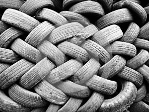 Piles of used tires in black and white.