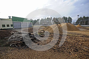 Piles of wood and wood chips which are used by the biggest in Ukraine boiler-house as biofuel. Slavutich, Ukraine