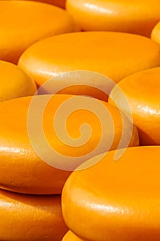 Piles of yellow Dutch cheese on a market