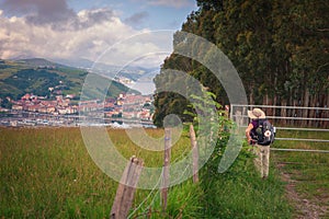 A pilgrim delights in the first views of Zumaia on the Way of St. James, Guipuzcoa, Spain