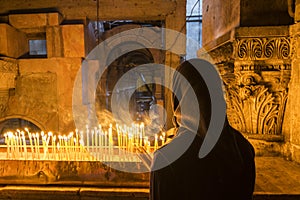 The pilgrim lit candles at the Church of the Holy Sepulchre in Jerusalem, Israel.