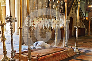Pilgrim prays over the Stone of Unction