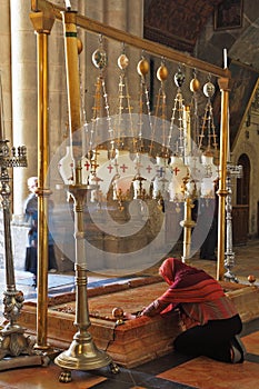 The pilgrim in red clothes passionately prays