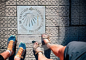 Pilgrimage at the Camino de Santiago. Sign shells and yellow arrow for piligrims on Way of St James, Camino de Santiago de