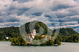 The Pilgrimage Church of the Assumption of Maria on a small island in the Lake Bled in Slovenia in late summer on a day with