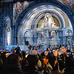 Pilgrims attend the Marian Torchlight Procession service at the Rosary Basilica in Lourdes