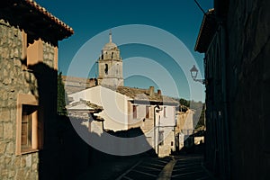 pilgrims walking a street in Castrojeriz town, province of Burgos, Spain - nov, 2021