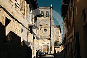 pilgrims walking a street in Castrojeriz town, province of Burgos, Spain - nov, 2021