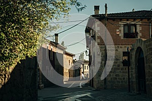 pilgrims walking a street in Castrojeriz town, province of Burgos, Spain - nov, 2021