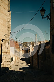 pilgrims walking a street in Castrojeriz town, province of Burgos, Spain - nov, 2021