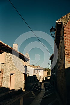 pilgrims walking a street in Castrojeriz town, province of Burgos, Spain - nov, 2021