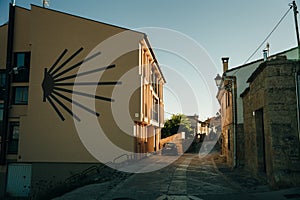 pilgrims walking a street in Castrojeriz town, province of Burgos, Spain - nov, 2021