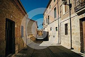 pilgrims walking a street in Castrojeriz town, province of Burgos, Spain - nov, 2021