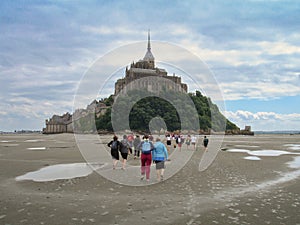 Piligrims walking to Mont Saint Michel