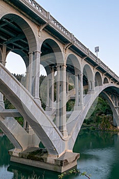 Pilings and arches of the Rogue River bridge in Gold Beach, Oregon at sunset