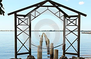 Pilings from old pier with Pagoda style frame at Thomas Edison Estate in Florida.