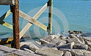 Pilings from pier and rocks