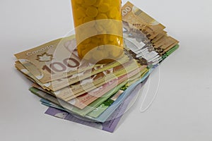 Pill bottle and Canadian Money Hundreds