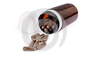 Pill bottle and scattered medical pills. Isolated medicaments