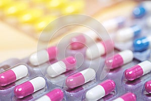 Pill bottle spilling out. colorful pills on to surface tablets background.