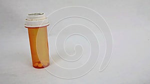 Pill bottle standing with white background panning back and forth