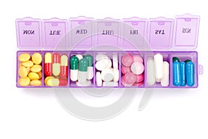 Daily pill box with medical pills isolated on white background. Top view. Flat lay