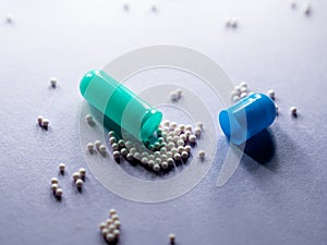 Pill capsule opened on the table. Macro close up. Medicine for the treatment of diseases. Vaccine and medicine pills. Health and c