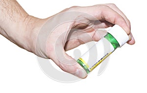 Pill container in hand on white background