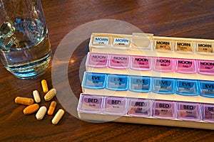 Pill container, pills, and water photo