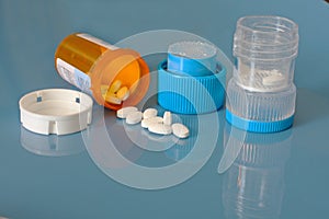 Pill crusher and prescription bottle with pills photo