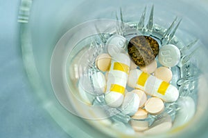 Pill and drug capsule and tablets in the glass