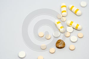 Pill and drug capsule and tablets on white background